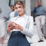 Business woman with smartphone on stairs with motion blur
