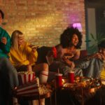 A group of friends at a party in a living room.