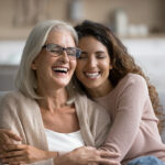 Two women hugging and smiling