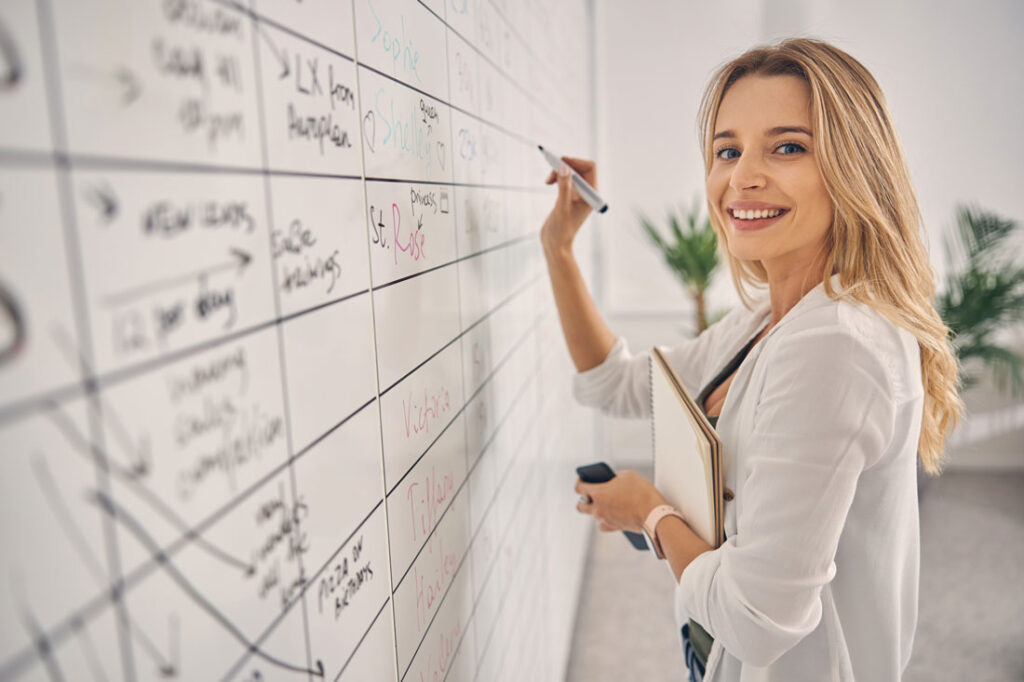 smiling women showing how to organize office for the best production work